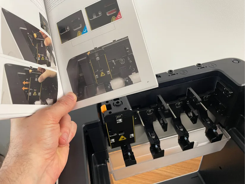 Snapmaker U1 setup process showing toolhead installation with printed manual instructions