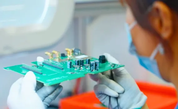 Technician inspecting an assembled printed circuit board for Bittele Electronics PCB assembly services