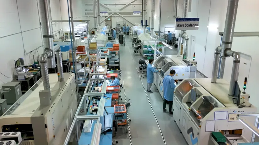 Bittele Electronics PCB assembly production floor with wave soldering equipment and technicians