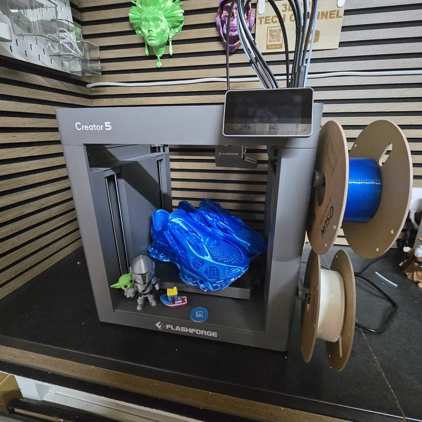Flashforge Creator 5 final print results Flashforge Creator 5 with completed multi-colour prints and TPU trainer inside the build area