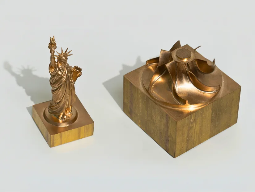 Brass Statue of Liberty and impeller samples machined with the InfiMaker K1 desktop 5-axis CNC