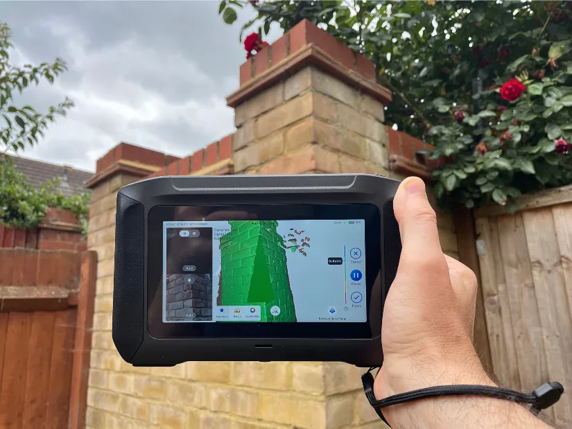 Creality Sermoon P1 used outdoors to scan a brick pillar, demonstrating the standalone workflow with the built-in 6-inch HD touchscreen.