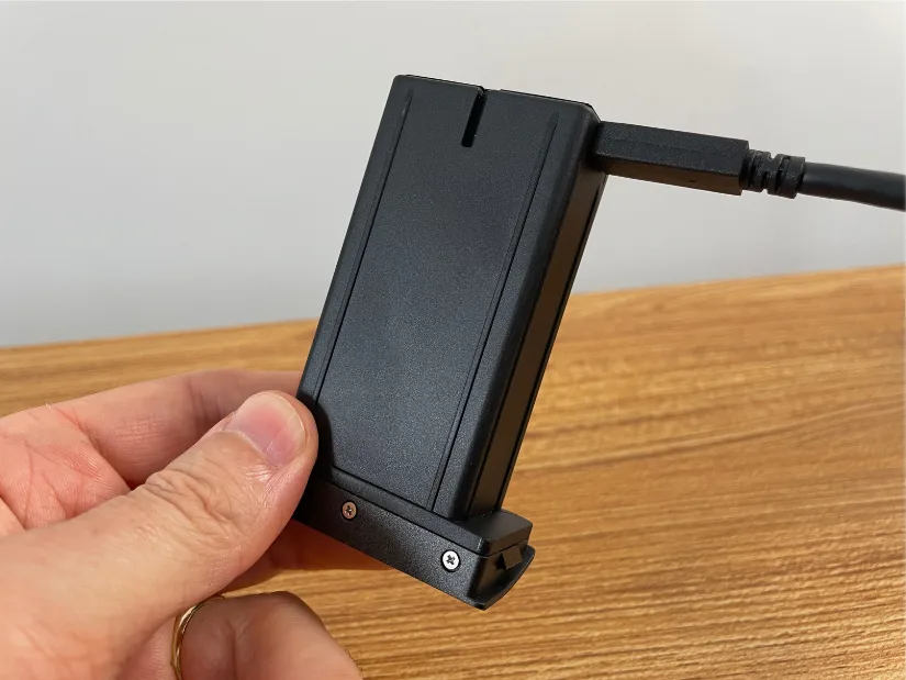 Spare rechargeable battery for the Creality Sermoon P1 being charged directly via the supplied USB cable.