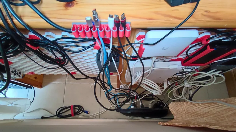 Honeycomb Storage Wall mounted under a desk for cable management, router storage, smart home gear, and charger accessories