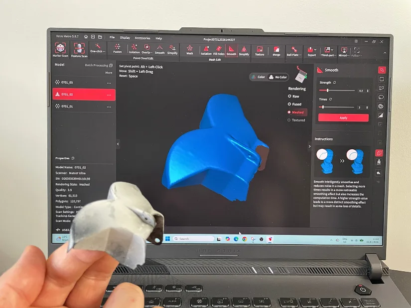 Cleaned RC boat reverse bucket mesh in Revo Metro before export, with the original scanned part held in front of the screen