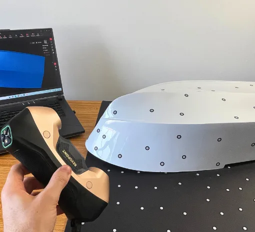 Revopoint MetroY Ultra 3D scanner scanning an RC boat hull with marker targets during hands-on testing