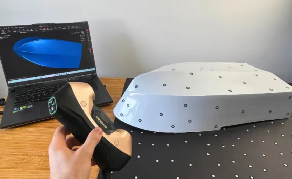 Revopoint MetroY Ultra 3D scanner scanning an RC boat hull with marker targets during hands-on testing