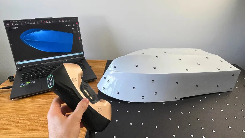 Revopoint MetroY Ultra 3D scanner scanning an RC boat hull with marker targets during hands-on testing