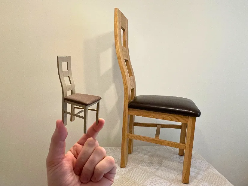 3D printed miniature replica of a wooden chair created from a Revopoint Trackit SR scan and shown beside the original chair.