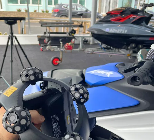 Revopoint Trackit SR 3D scanner being used to scan a Sea-Doo jet ski during hands-on field testing.