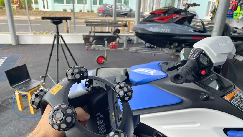 Revopoint Trackit SR 3D scanner being used to scan a Sea-Doo jet ski during hands-on field testing.