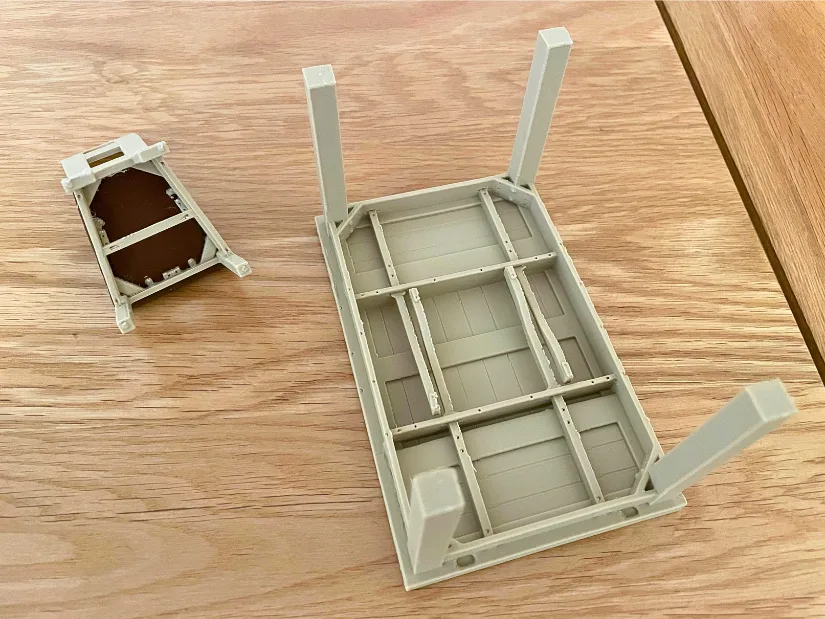 Underside of 3D printed table and chair miniatures showing structural details captured by the Revopoint Trackit SR.