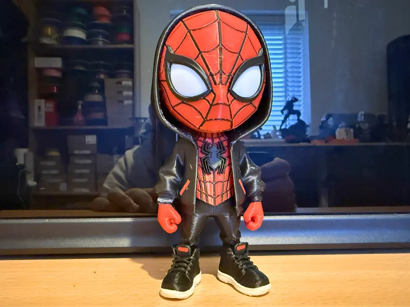 Hooded Spider-Man figurine with black jacket, detailed red mask and sneakers 3D printed on the Bambu Lab H2C