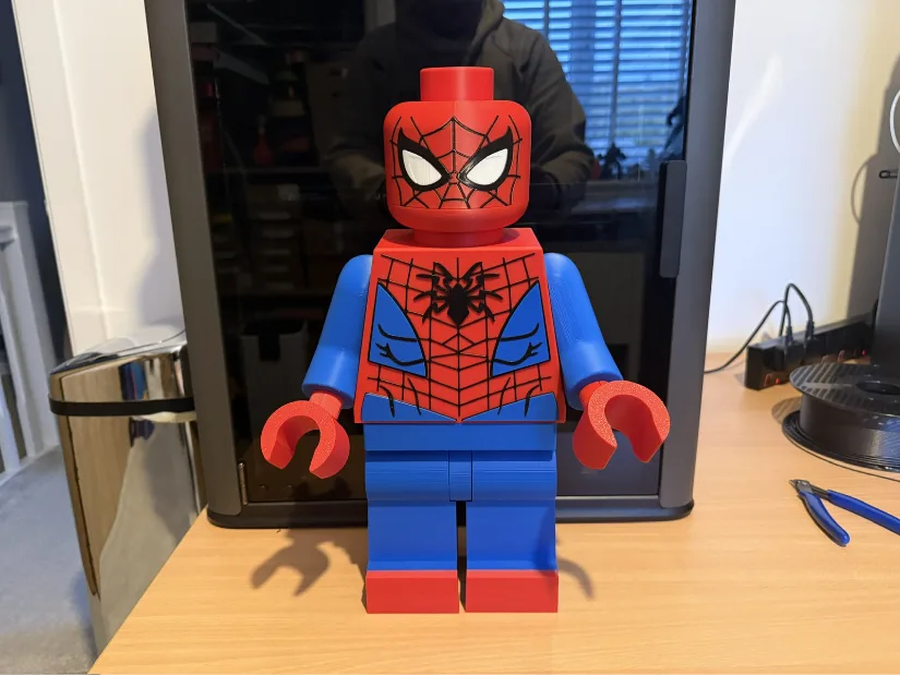 Large LEGO-style Spider-Man figure 3D printed in red, blue and black on the Bambu Lab H2C