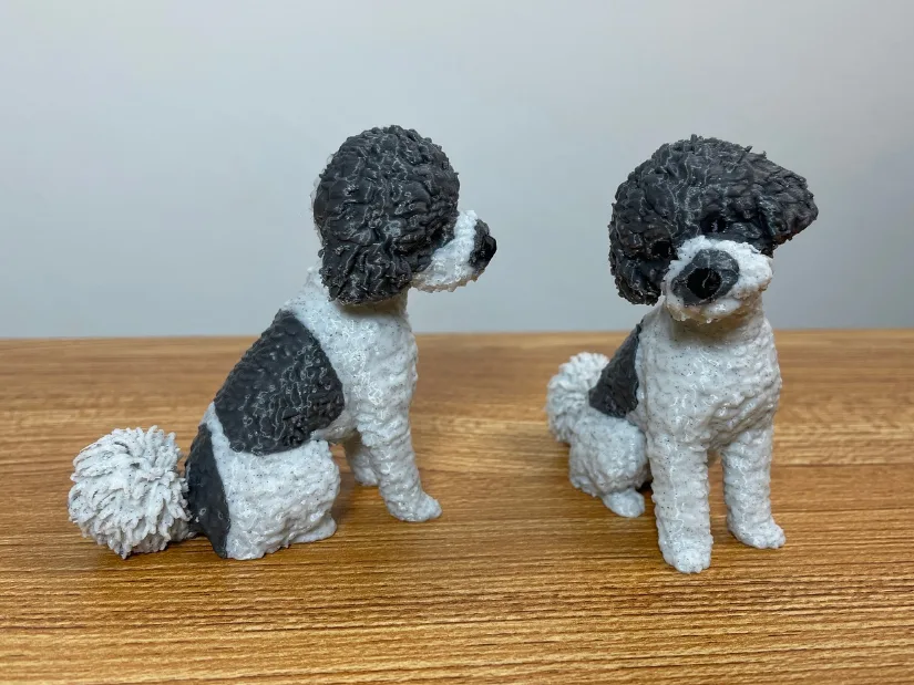 Two 3D printed Ella dog figurines created with Meshy AI