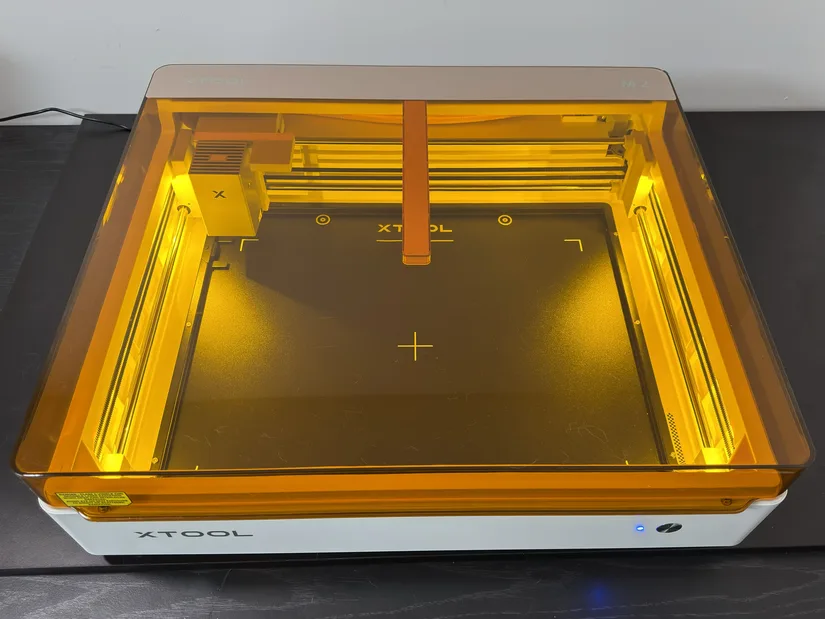 xTool M2 desktop laser machine with orange protective lid