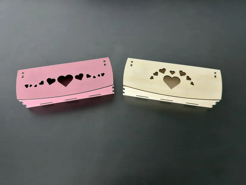 Two heart-themed hinged storage boxes laser cut from pink MDF and basswood