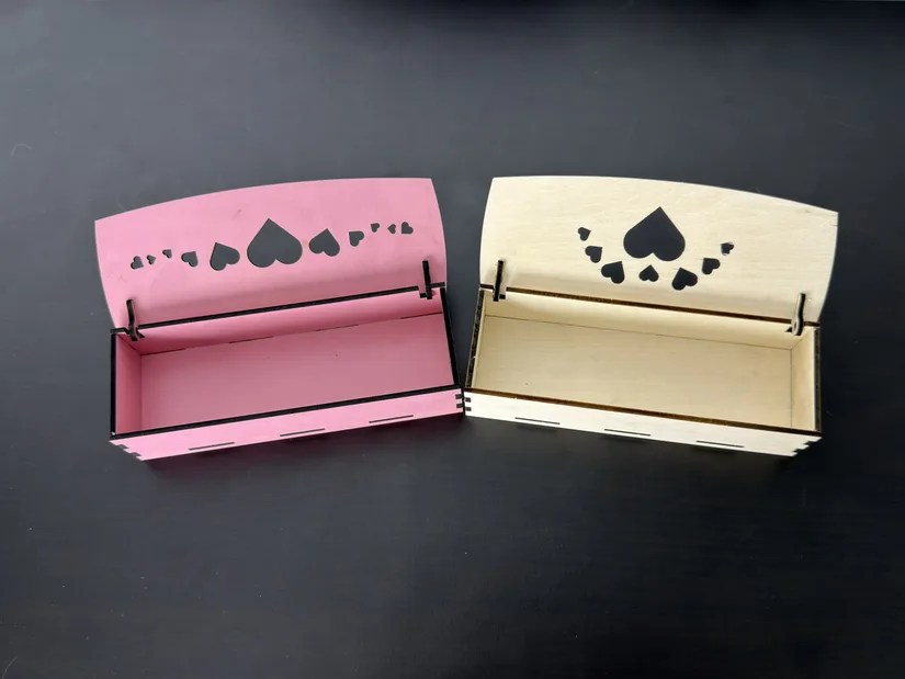 Pink MDF and basswood hinged boxes open after cutting with the xTool M2