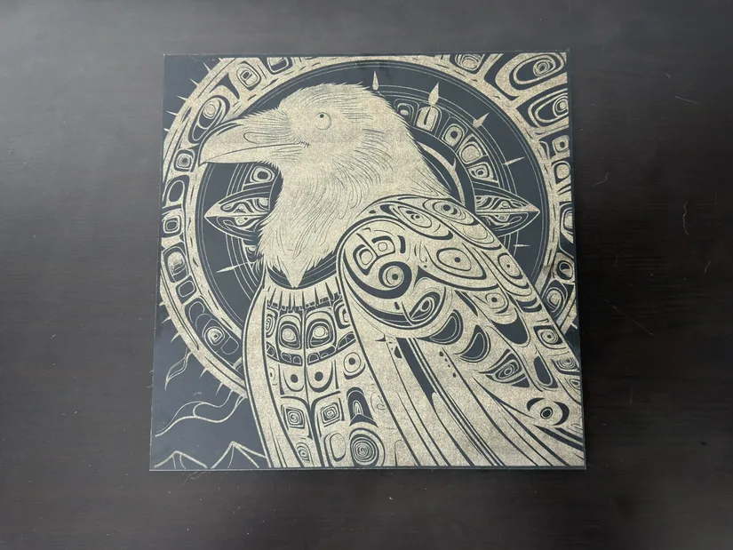 Close-up of a raven engraving on black MDF made with the xTool M2