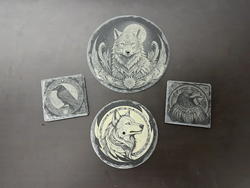 Several xTool M2 slate engravings featuring raven and wolf artwork